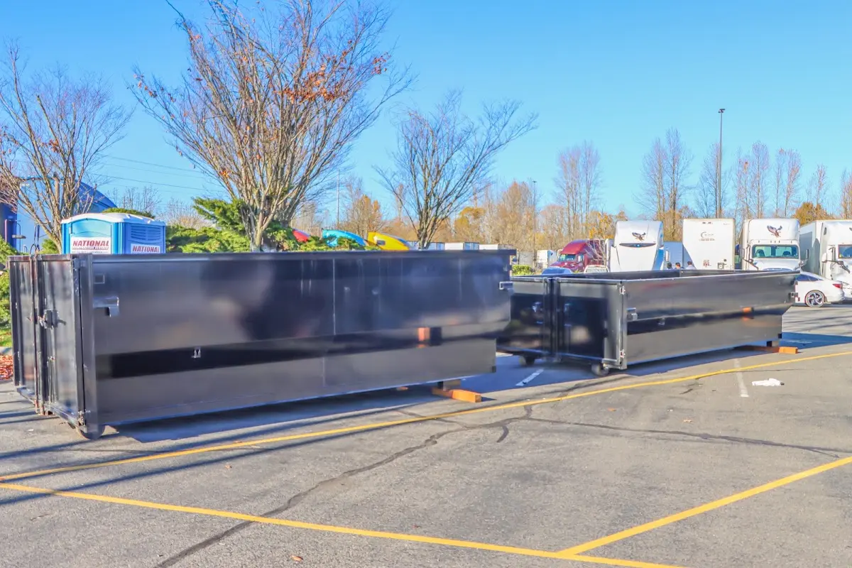 Professional dumpster rental service with roll-off container on residential driveway in Huntingburg